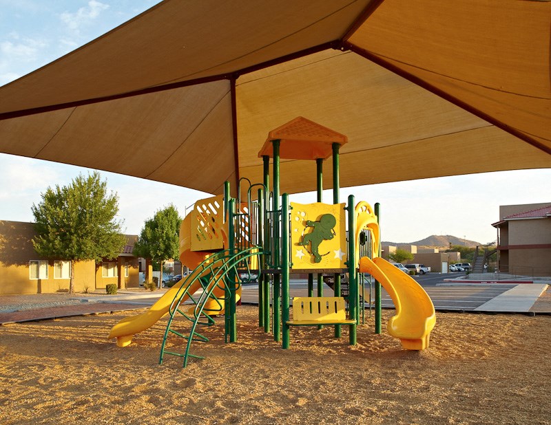 a playground with a swing set and slides