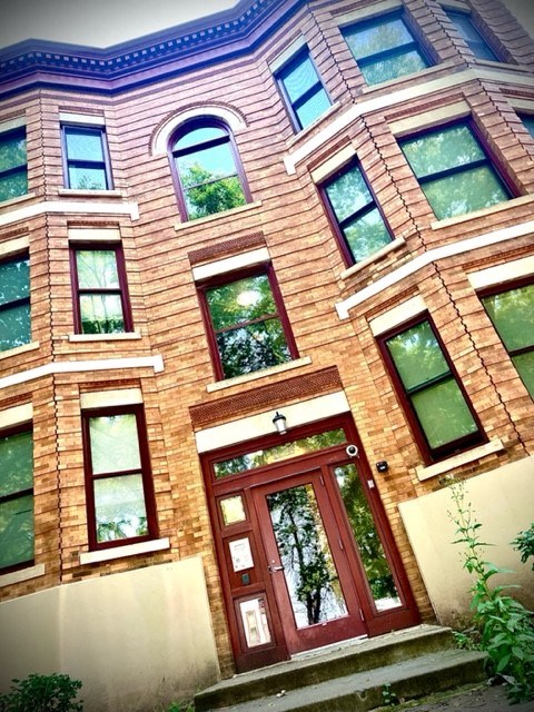 a large brick building with a red door