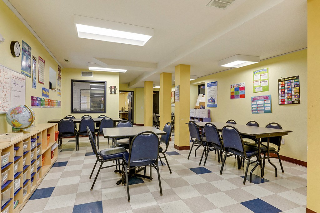 a classroom at a school with tables and chairs