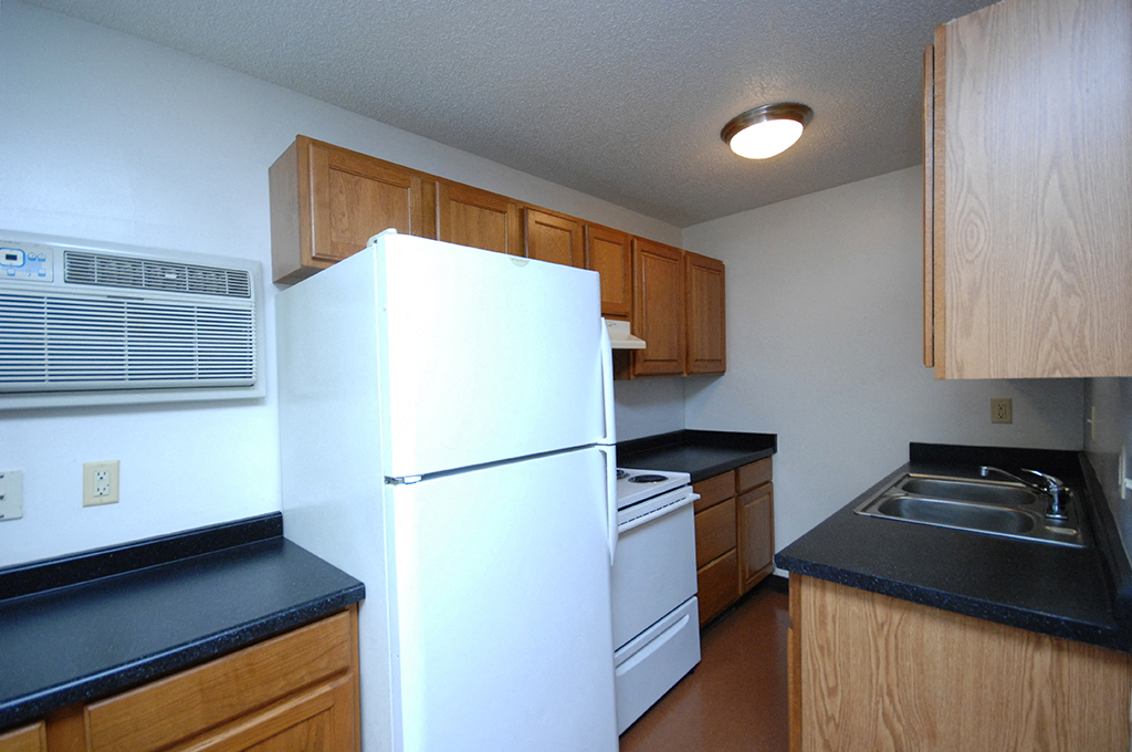 a kitchen with a refrigerator and a sink