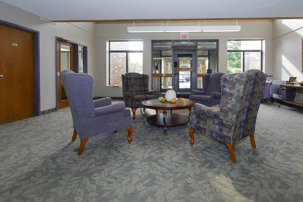 a living room with chairs and a table