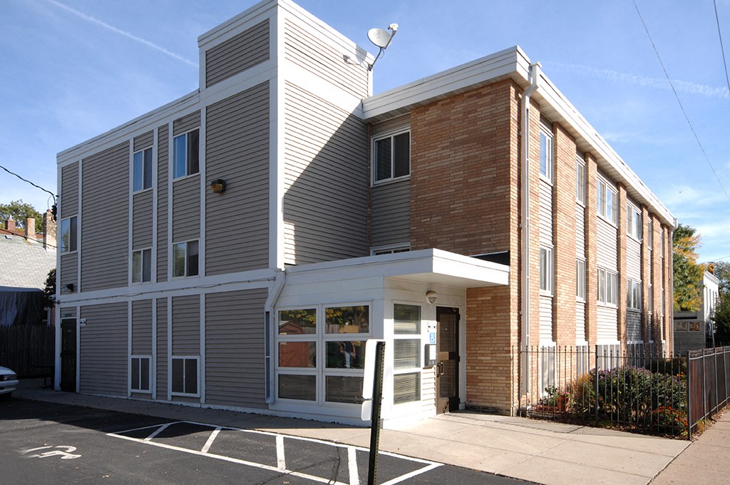 the front of a building with a porch and a street light
