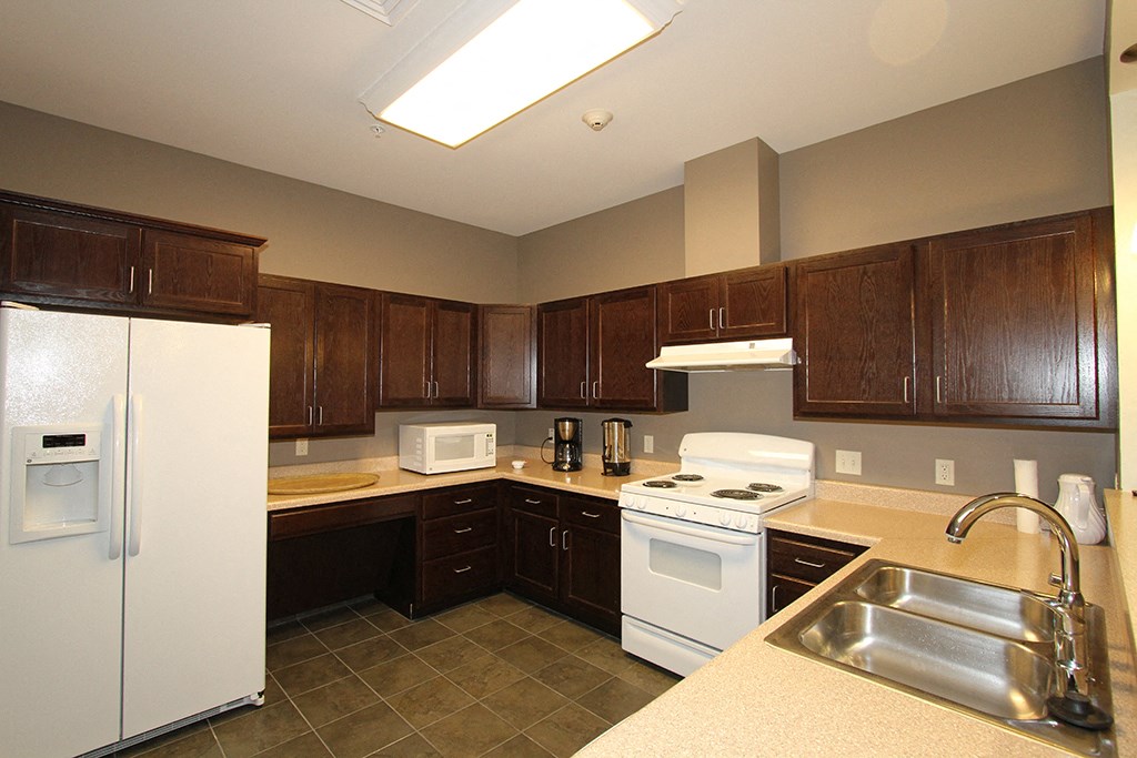 a kitchen with white appliances and wooden cabinets