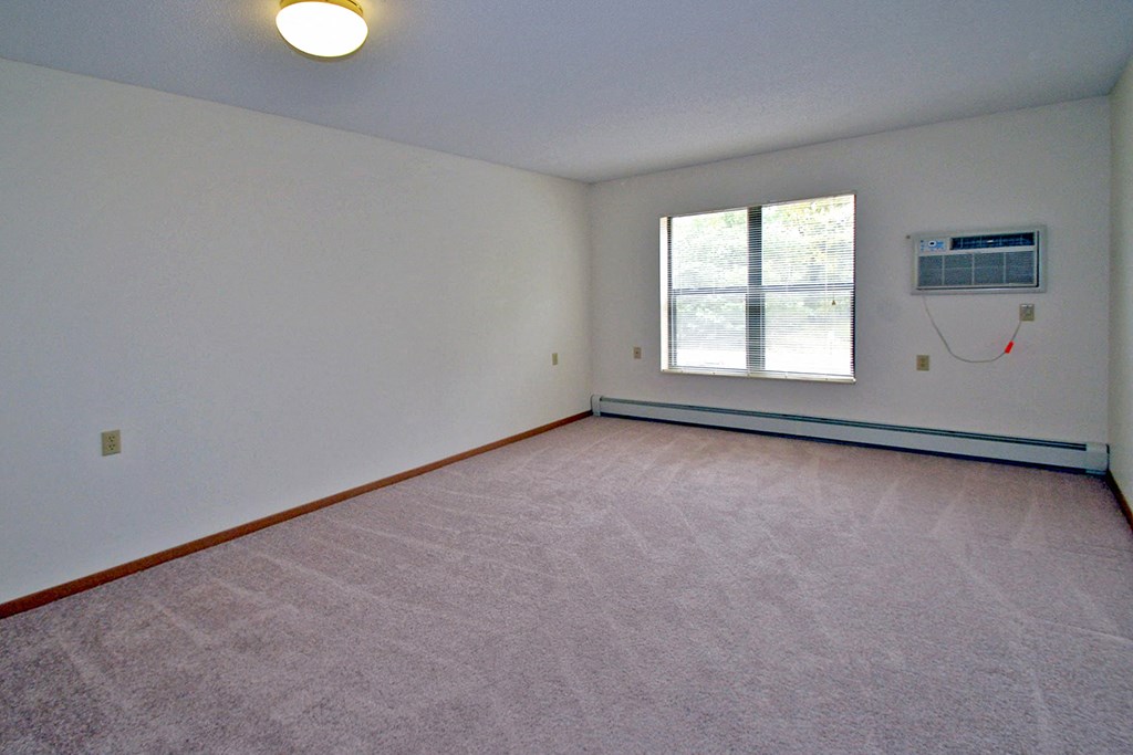 the living room of a home with a heater and a window