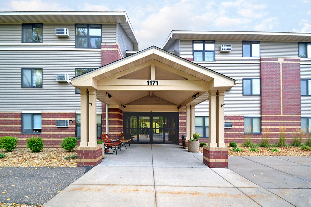 the entrance to a building with a covered walkway