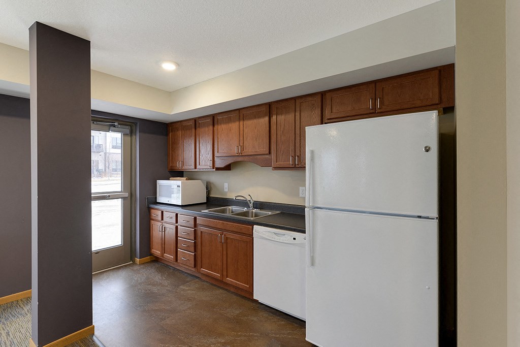 a kitchen with white appliances and wooden cabinets