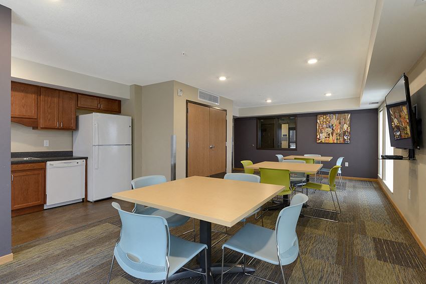 a dining room with a table and chairs and a kitchen
