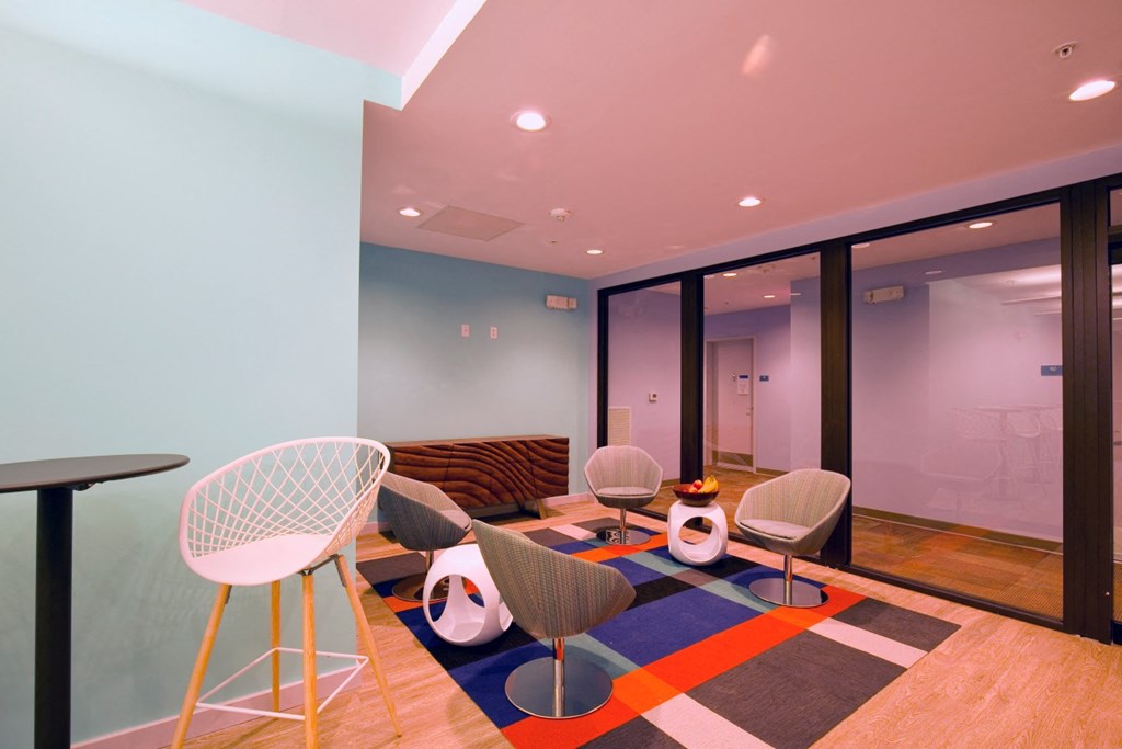 a living room with chairs and a table and glass doors