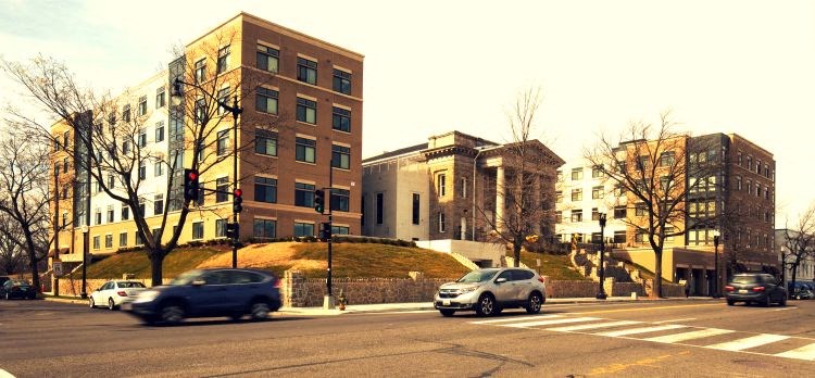 a busy city street with cars and buildings