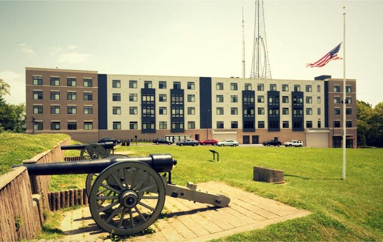 a cannon sitting in front of a large building