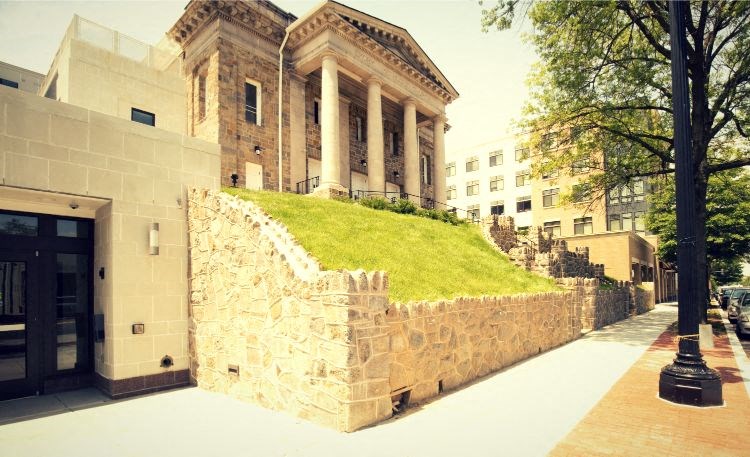 a stone wall in front of a building