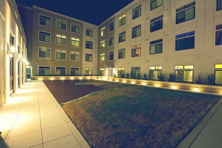 a large building with a lawn in front of it