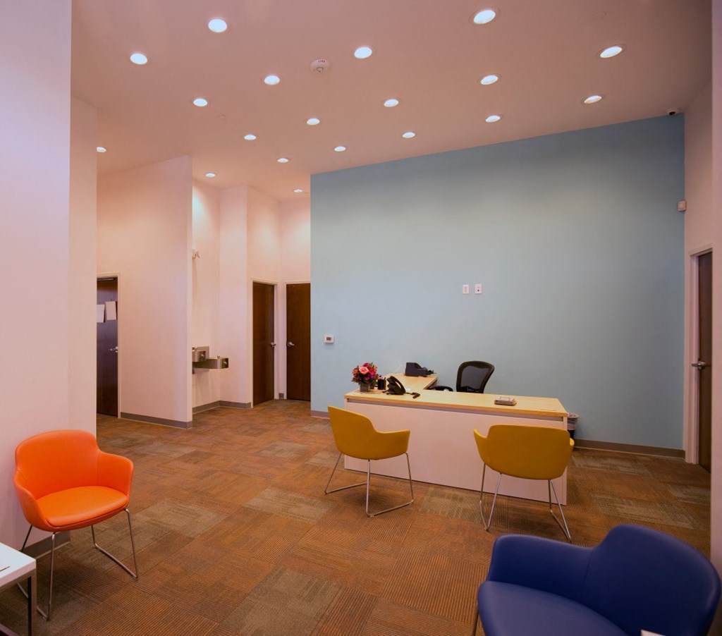 a conference room with a desk and chairs