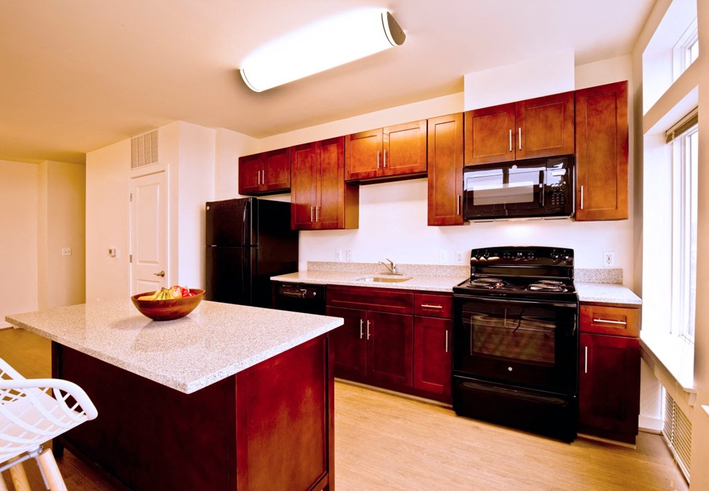 a kitchen with black appliances and wooden cabinets