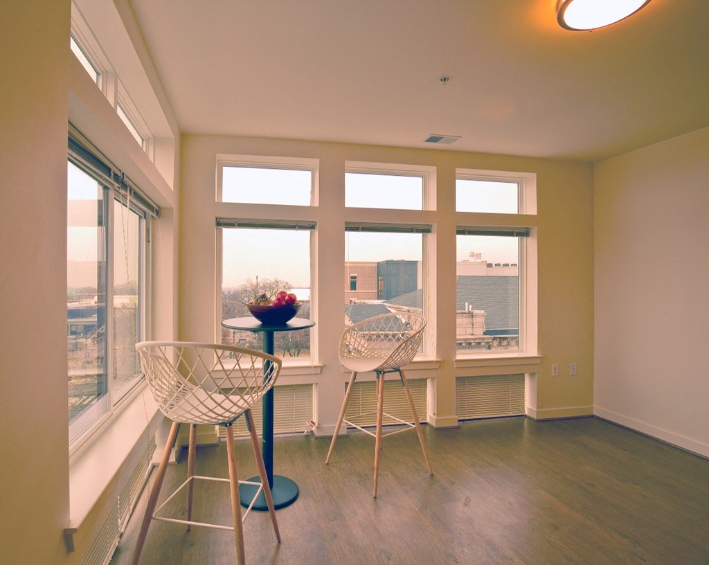 a living room with two chairs and a window