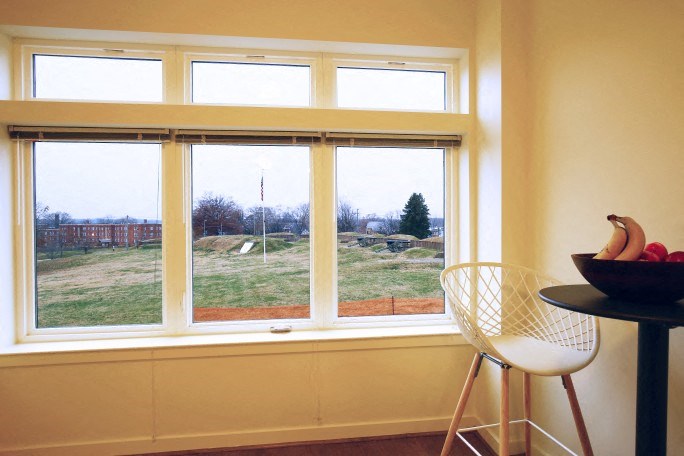 a window with a bowl of fruit on a table