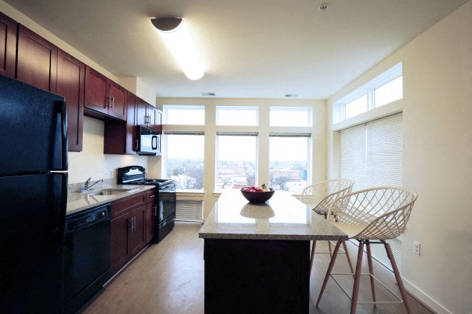 a kitchen with a table and chairs and a large window