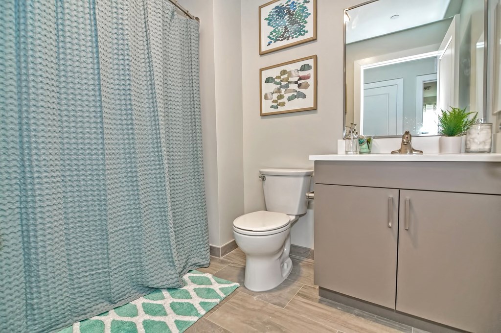 a bathroom with a shower and a toilet and a sink