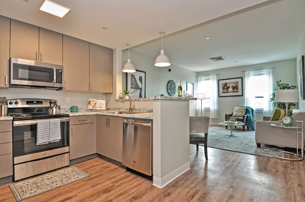 a kitchen with an island and a living room with a couch
