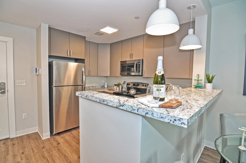a kitchen with a counter top with a bottle of wine on it