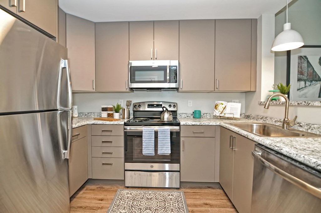 a modern kitchen with stainless steel appliances and granite counter tops