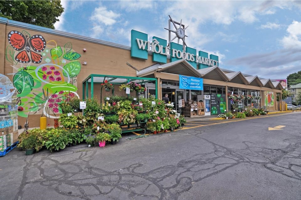 a store with flowers and plants in front of it