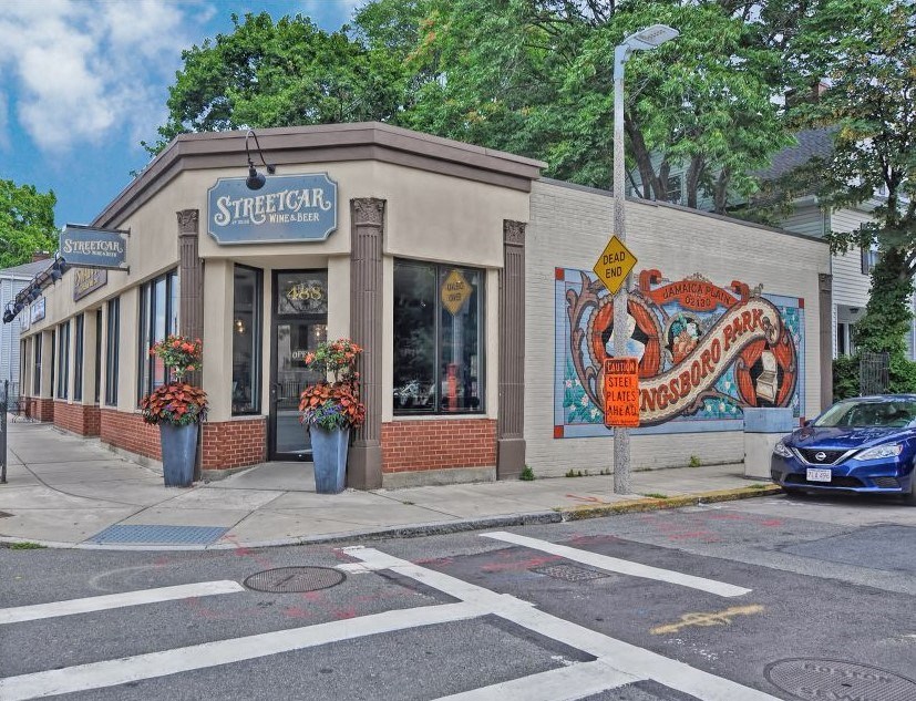 a street corner with a building with a mural on the side