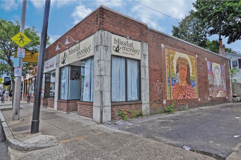 a brick building with a mural on the side of it