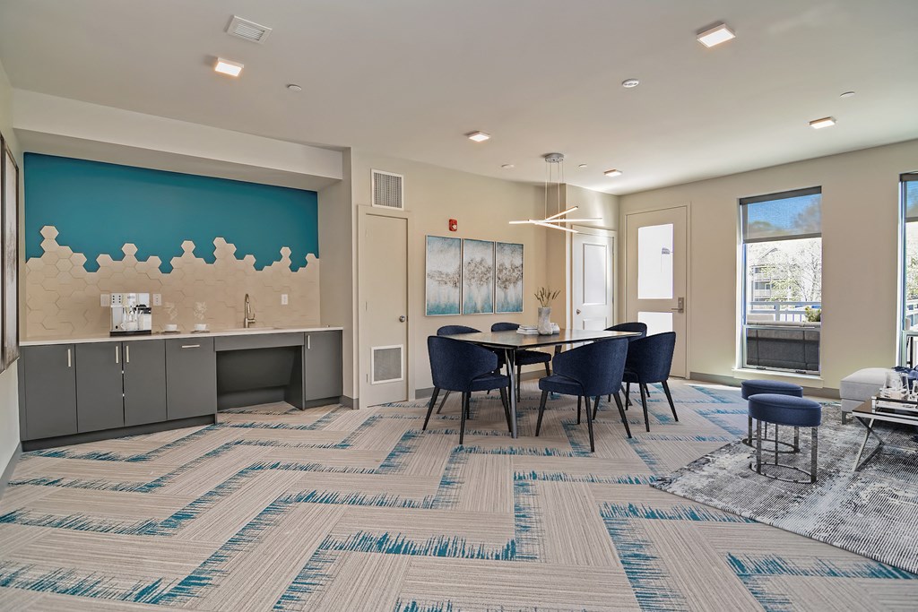 a dining room with a table and chairs and a kitchen