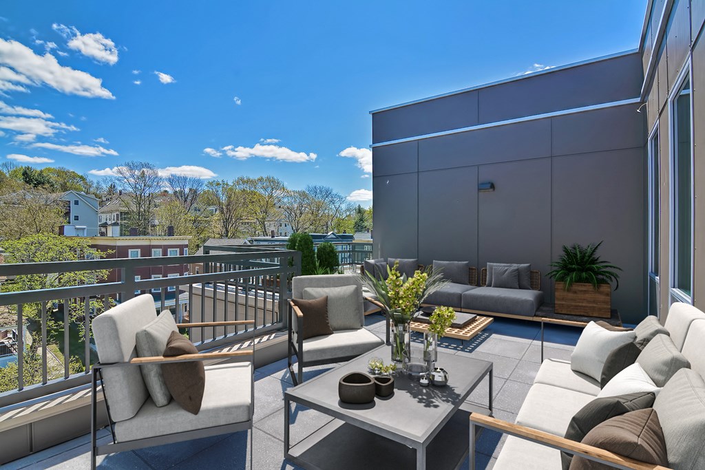 a furnished balcony with couches and a coffee table