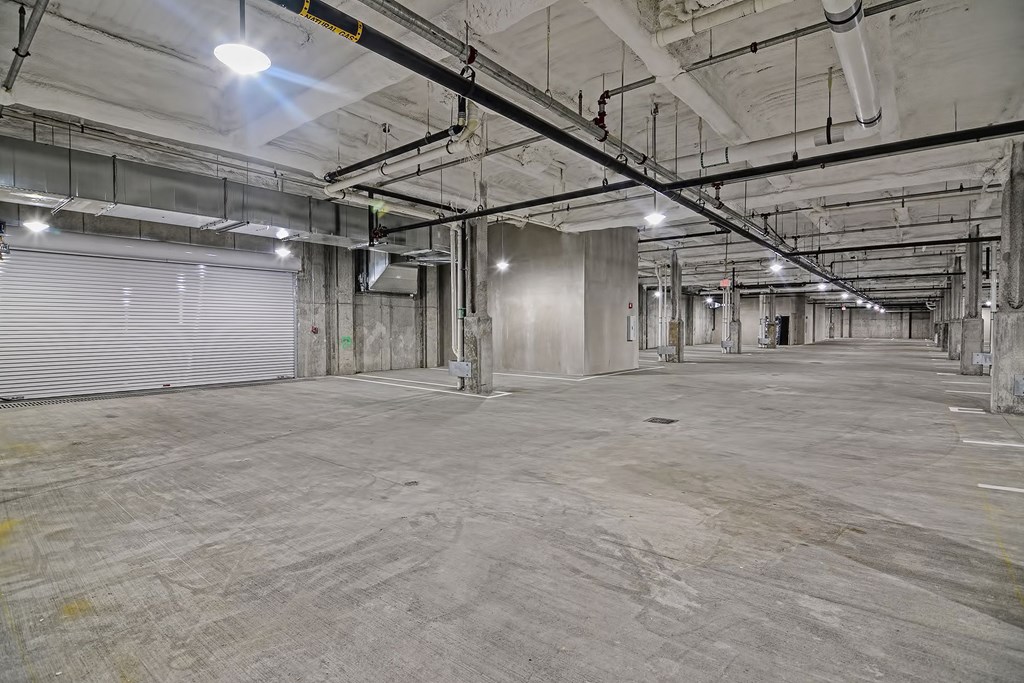 the interior of a large warehouse with a large garage door