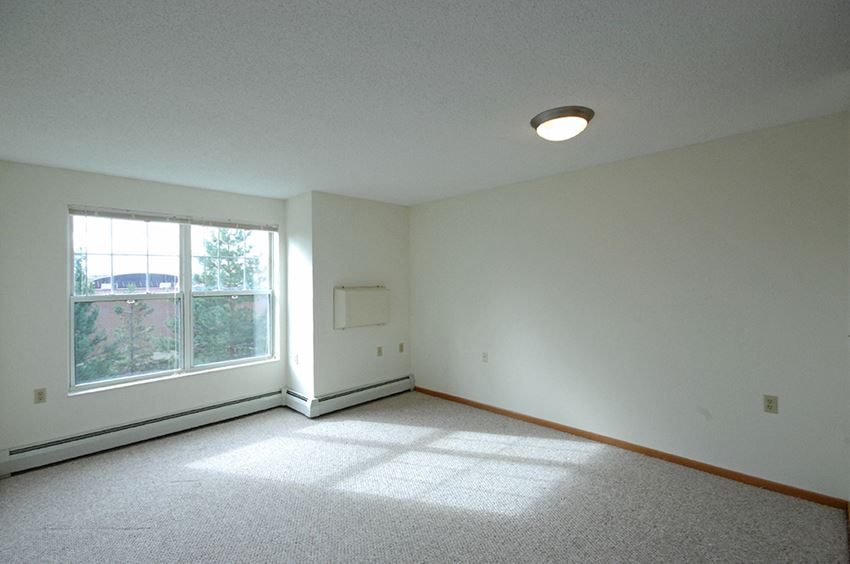 an empty living room with a large window