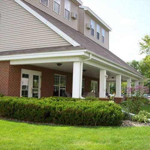 a house with a covered porch and a lawn