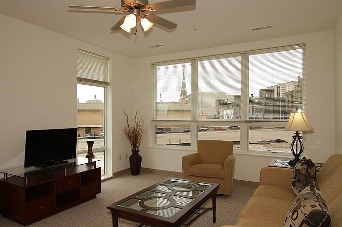 a living room with a couch chair and a television