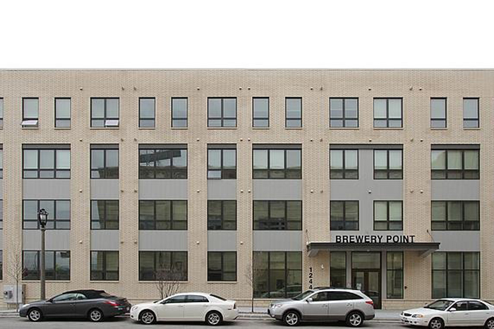 a large brick building with cars parked in front of it