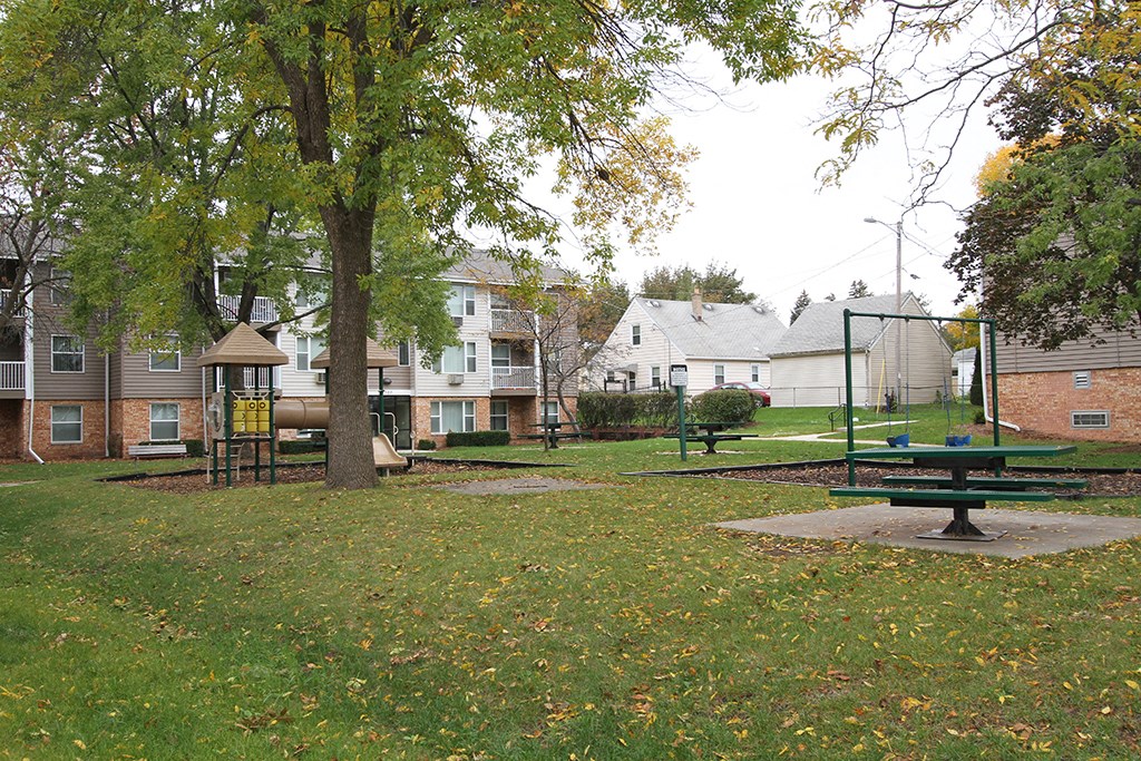 a park with a playground and a swing set