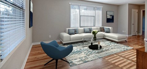 A living room with a white couch and a blue chair.