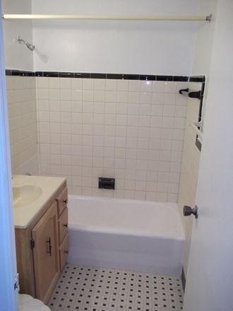 a small bathroom with a tub and a sink