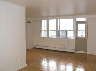 an empty living room with a large window