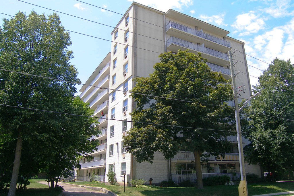 an apartment building with trees in front of it