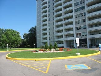 an empty parking lot in front of an apartment building