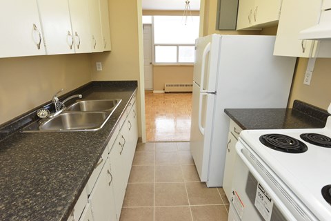 a kitchen with granite counter tops and white appliances