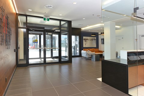 a view of the lobby of a building with glass doors