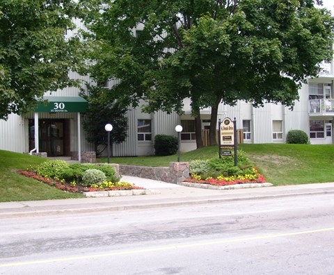 A building with the number 30 on it is surrounded by greenery.