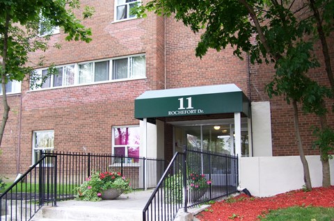 A building with a green awning and the number 11 on it.
