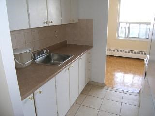 a kitchen with a sink and white cabinets