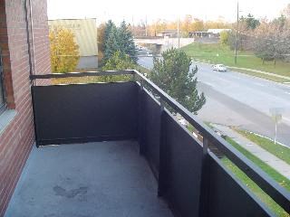 a balcony with a view of a street and a building