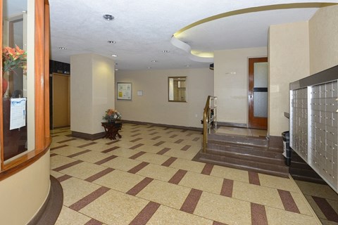 the lobby of a building with a hall way and stairs