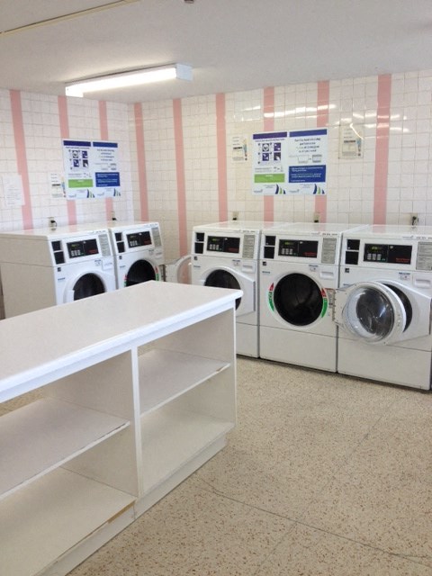 a row of washing machines in a laundromat