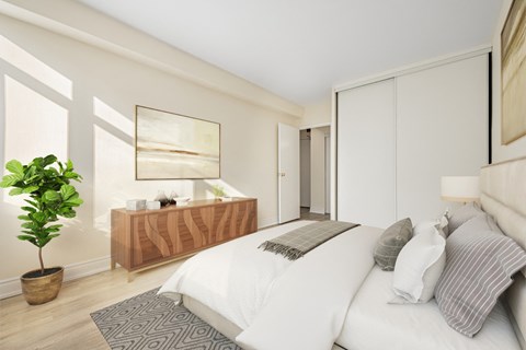 A bedroom with a large bed and a wooden dresser.